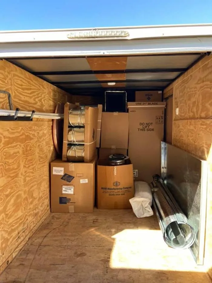 Ductwork and parts staged in an Air Works trailer before a job
