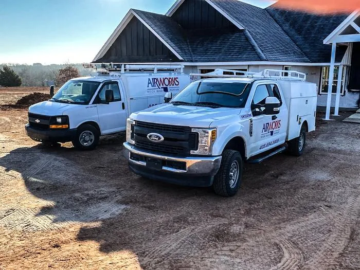 Air Works service trucks parked on site at a job in the Oklahoma City area